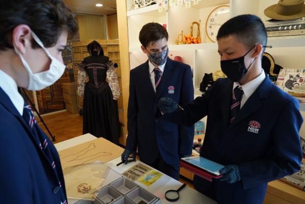 Scholars Lawson, Daniel and Edison undertaking a hands-on learning activity at t
