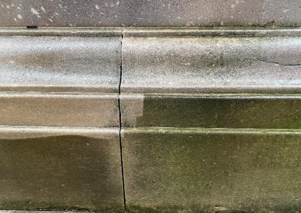 Close-up of cleaned section of base, before conservation. 