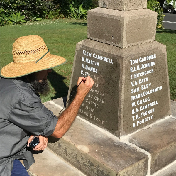 Inscription painting on the Celtic Cross War Memorial, Gosford.