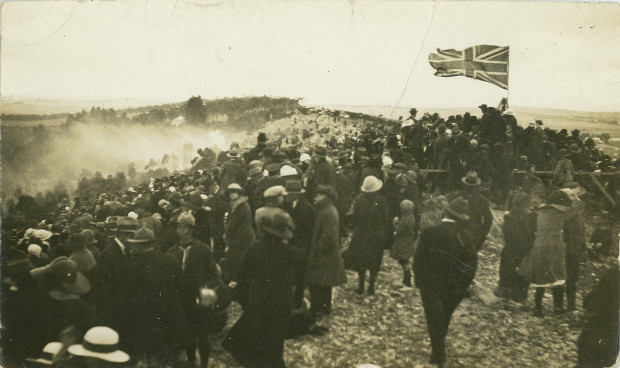 Returned Soldiers and community carry rocks to the memorial site