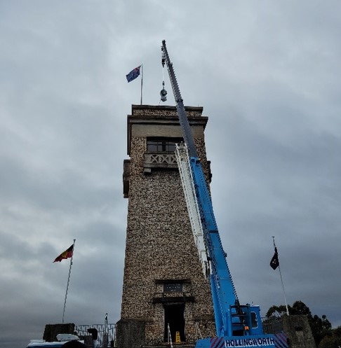 Restored beacon being lowered on to the Tower.